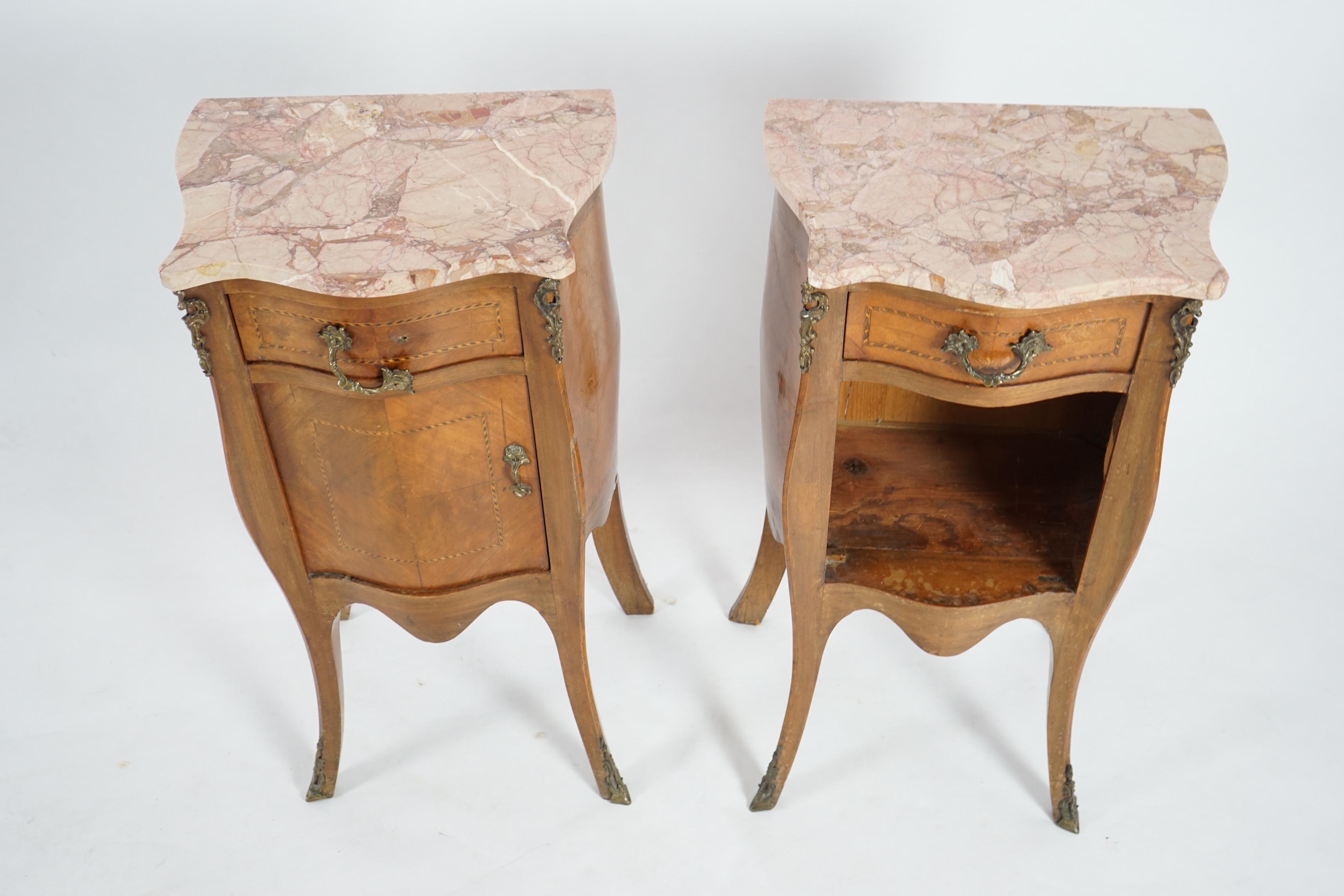 A pair of French marbled top inlaid mahogany bedside chests